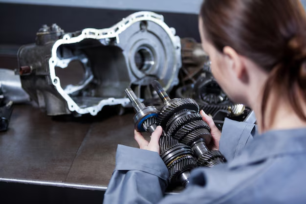 A female mechanic holding engine parts